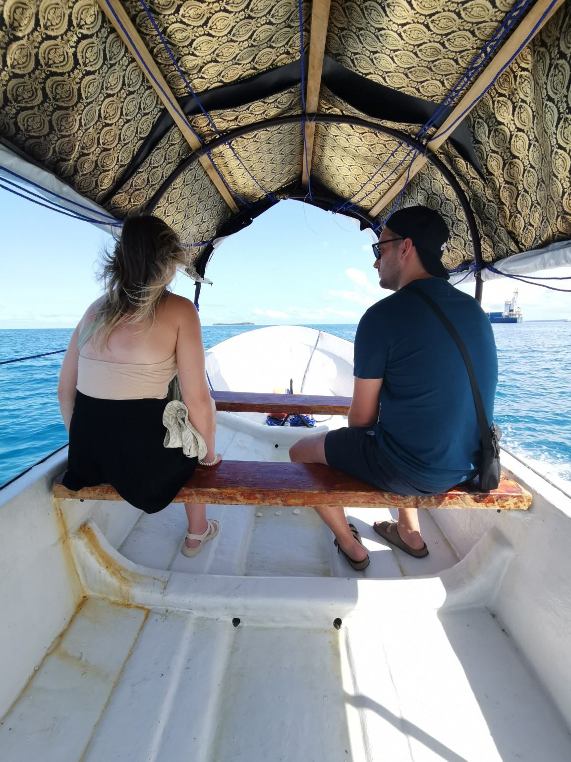 Guests seated in a boat transfer heading to or from Prison Island